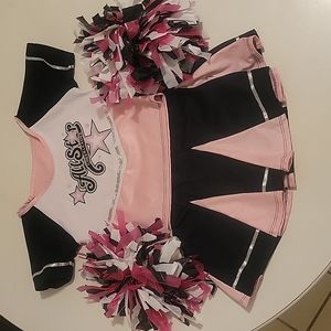 Girl play cheer costume with pom poms, size X small.